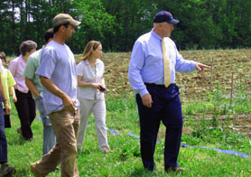 Photo of Matt Conver showing Secretary Kuperus his organic farm - Click to enlarge