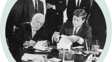 John Kennedy signing an agreement
