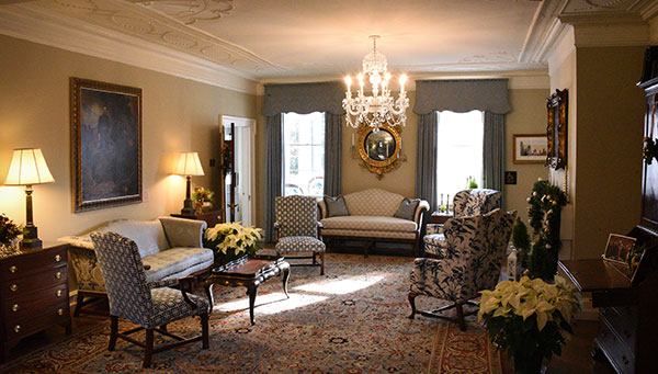 photo - Sunlight pours through Parlor windows where Warren Garden Club graces the room with white poinsettias, gold and green seasonal decor. Elegant details, furniture and carpet fill the room.