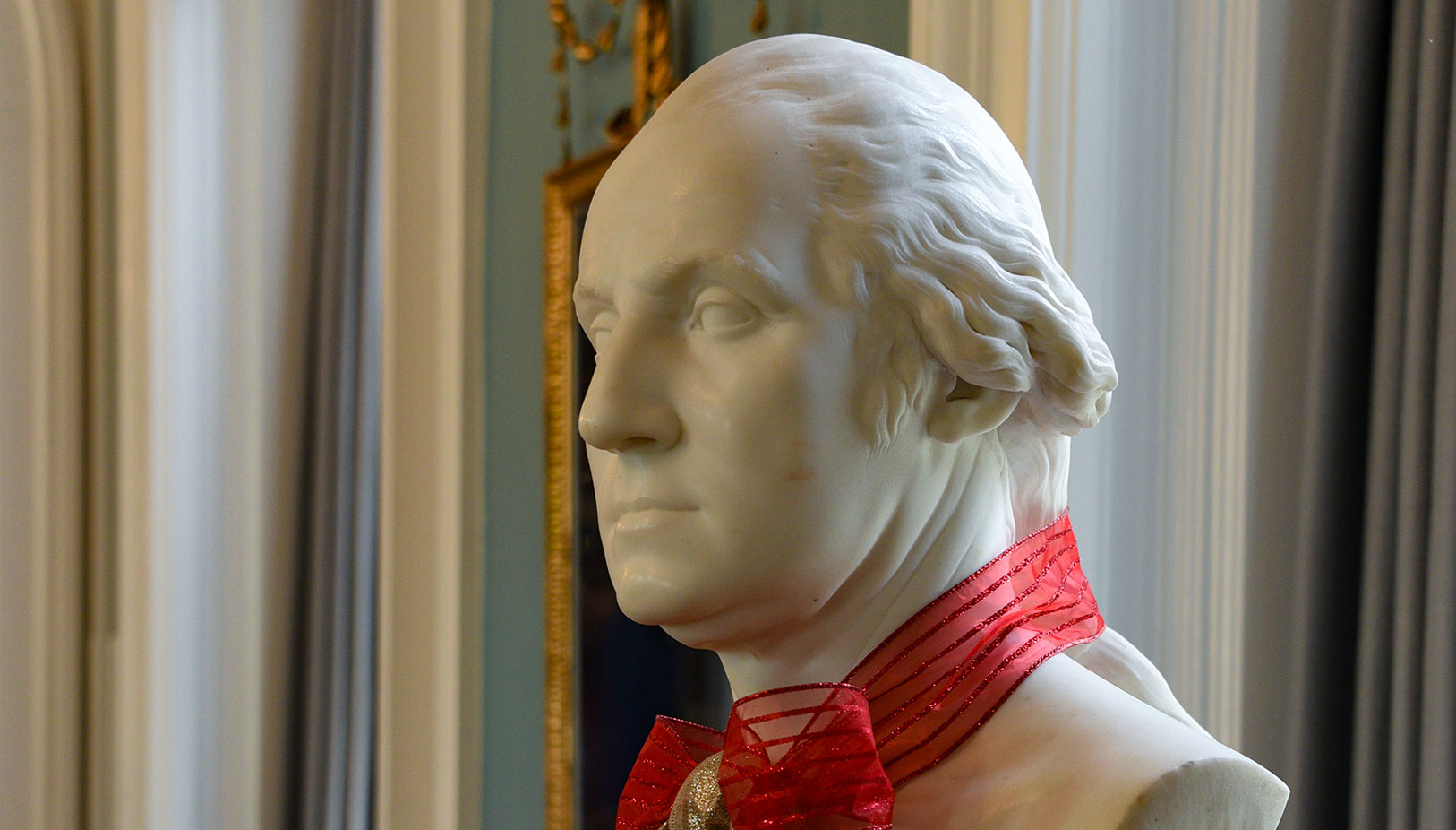 photo - The bust of George Washington in the Music Room sports a sparkling red and gold ribbon. 