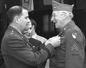 Maj. Gen. Glenn K. Rieth (left), awards a veteran with the NJ Distinguished Service Medal (Click to Enlarge)