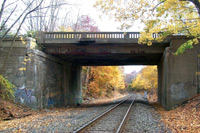 photos of railroad tracks below bridge